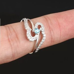 2wings or hearts holding an aquamarine sz7